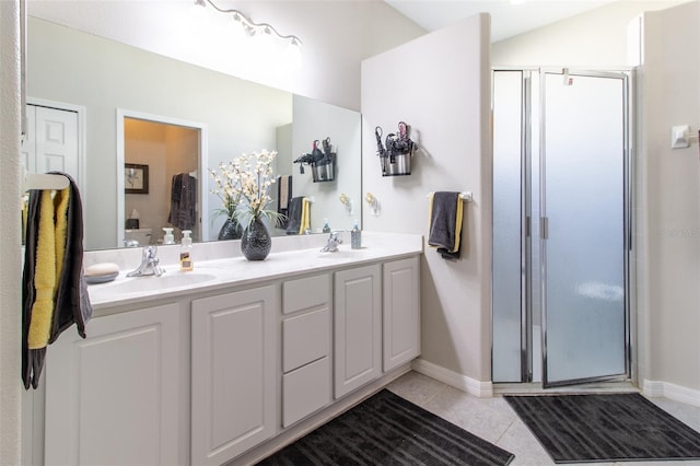 bathroom featuring tile patterned flooring, vanity, and a shower with shower door