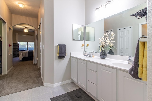 bathroom with tile patterned floors, ceiling fan, vanity, and a textured ceiling