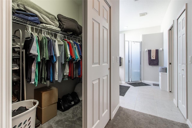 walk in closet with light tile patterned floors