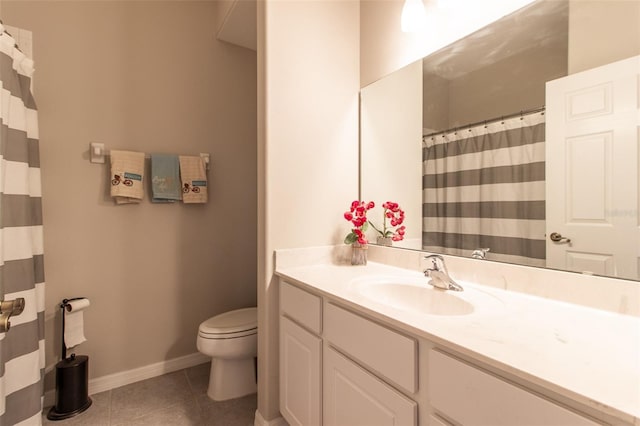 bathroom with tile patterned flooring, vanity, and toilet