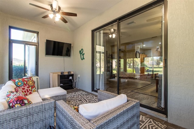 living room featuring ceiling fan and wood-type flooring