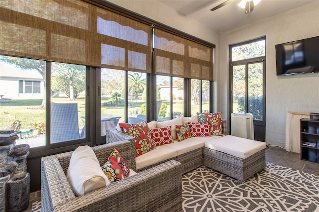 sunroom / solarium featuring ceiling fan