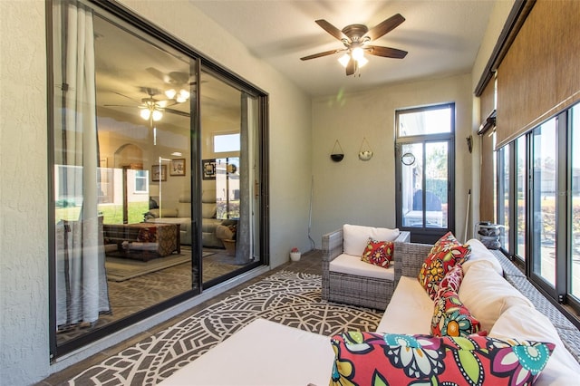 sunroom / solarium featuring ceiling fan and a wealth of natural light