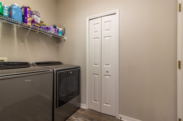 washroom with washer and clothes dryer and dark hardwood / wood-style floors