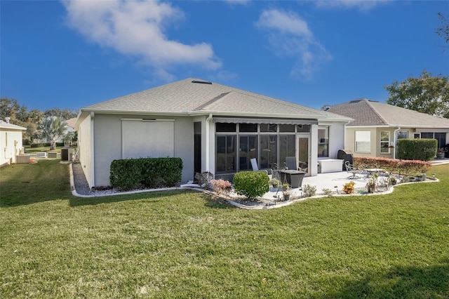 back of house with a sunroom, a yard, and central AC unit