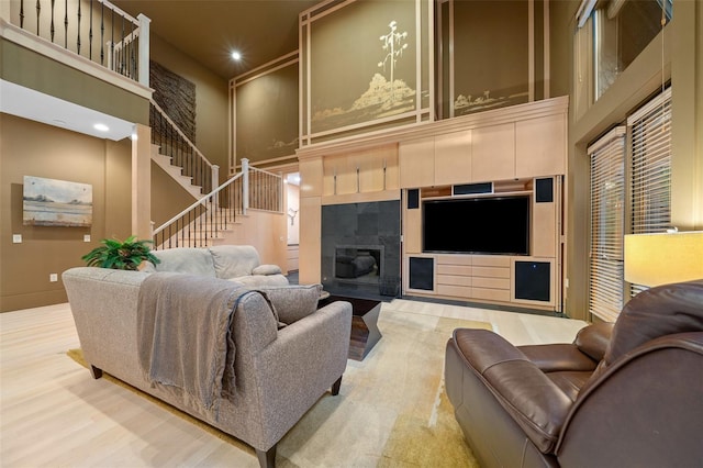 living room featuring a towering ceiling and wood-type flooring