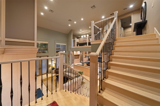 stairway with hardwood / wood-style floors