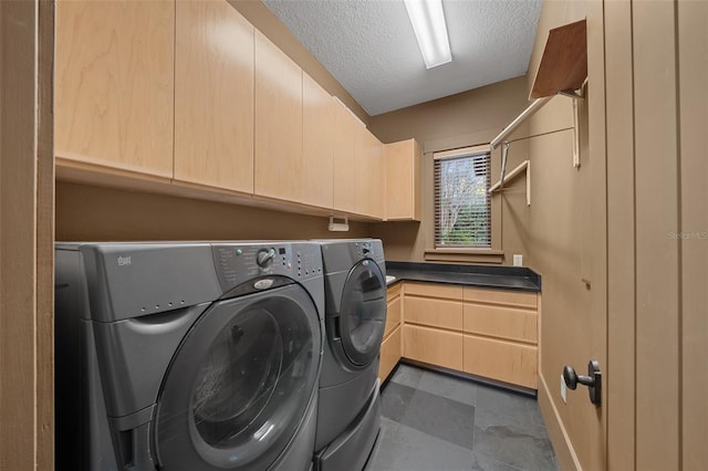 clothes washing area with cabinets, independent washer and dryer, and a textured ceiling