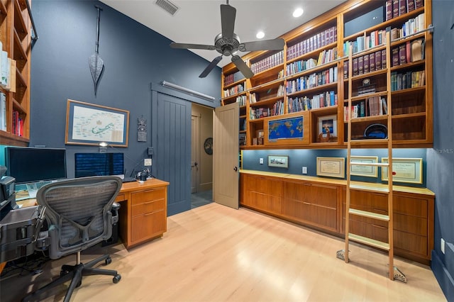 home office featuring ceiling fan and light hardwood / wood-style flooring