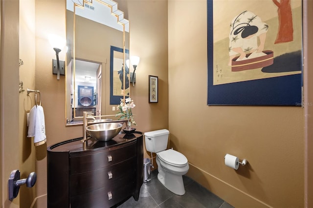 bathroom with tile patterned floors, vanity, and toilet