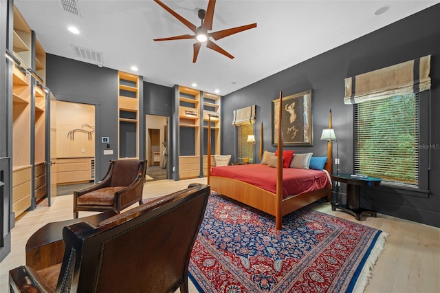 bedroom with light hardwood / wood-style flooring and ceiling fan