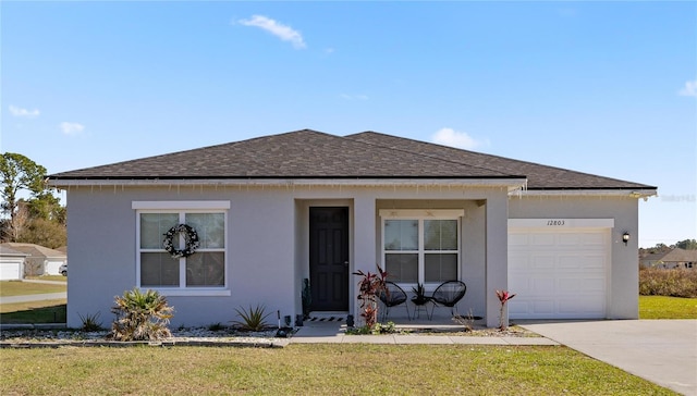 view of front facade with a front yard and a garage