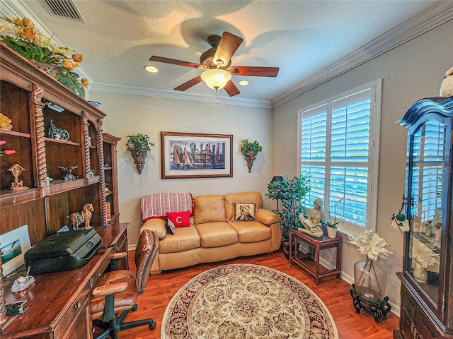 office space with crown molding, hardwood / wood-style floors, ceiling fan, and a textured ceiling