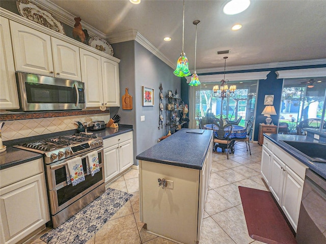 kitchen featuring tasteful backsplash, a notable chandelier, crown molding, decorative light fixtures, and appliances with stainless steel finishes