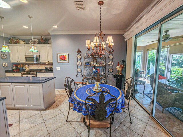 dining room with ceiling fan with notable chandelier, ornamental molding, and light tile patterned floors