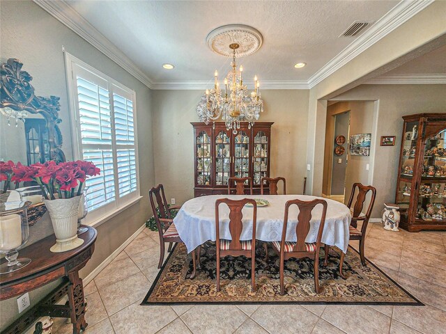 dining space with a textured ceiling, crown molding, a notable chandelier, and light tile patterned flooring