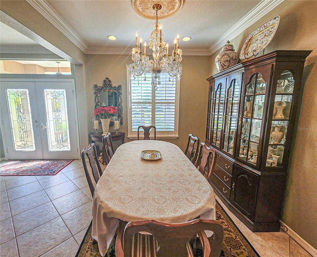 tiled dining area featuring a chandelier, crown molding, and french doors