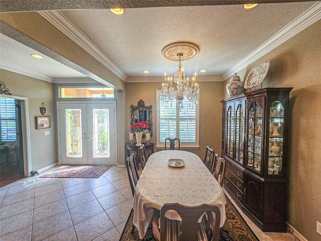 dining space featuring french doors, an inviting chandelier, crown molding, a textured ceiling, and light tile patterned flooring