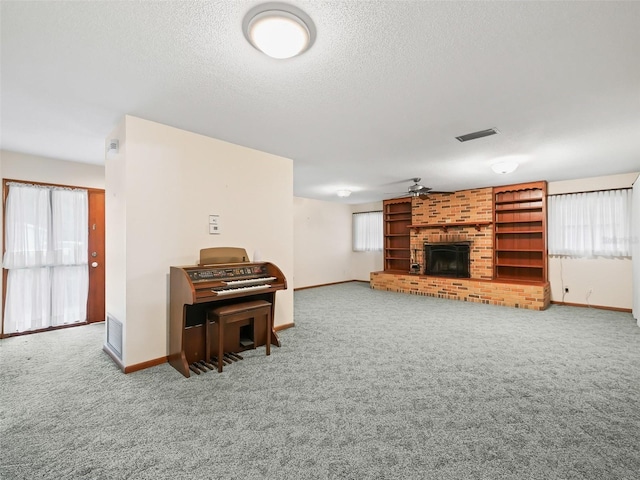 living room with a fireplace, carpet, and ceiling fan