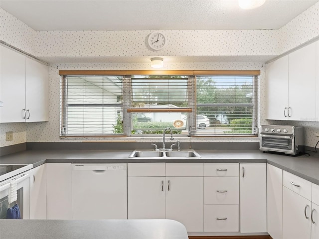 kitchen featuring white cabinetry, sink, and white appliances