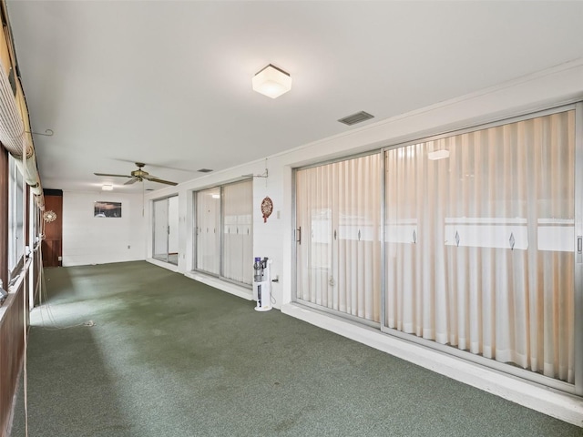 unfurnished room with plenty of natural light and ceiling fan