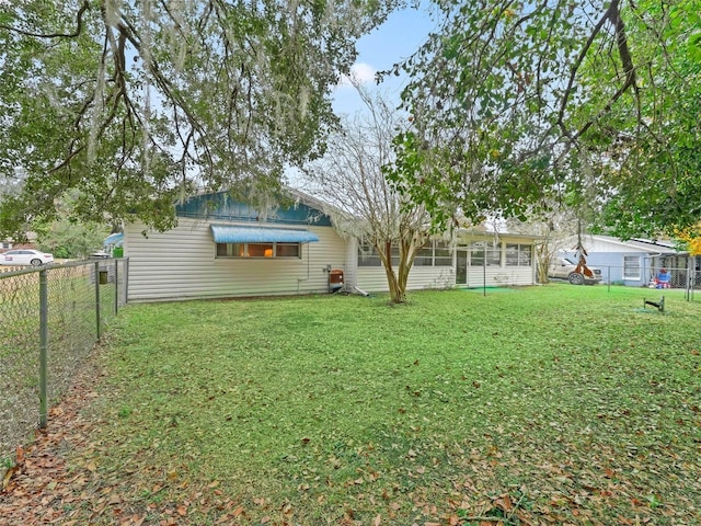 back of house with a lawn