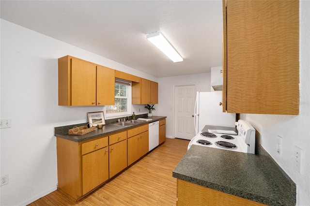 kitchen with a textured ceiling, light hardwood / wood-style flooring, white appliances, and sink