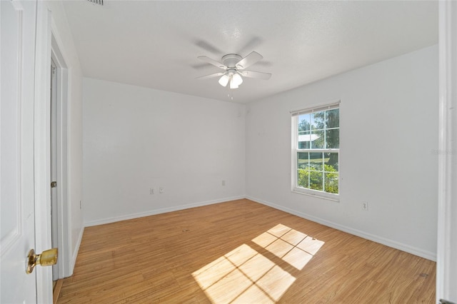 unfurnished room with light wood-type flooring and ceiling fan