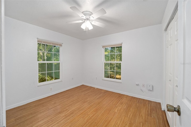 empty room featuring ceiling fan and light hardwood / wood-style floors