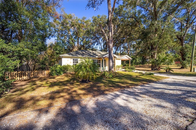 ranch-style home with a front lawn