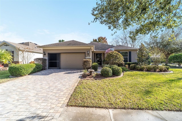 ranch-style house with a garage and a front lawn