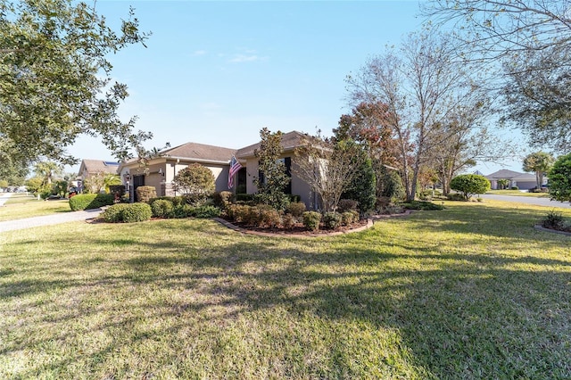 view of front of home featuring a front yard and a garage