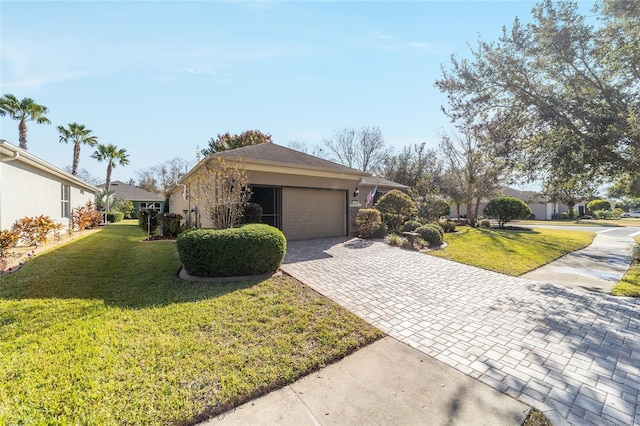 single story home with a front yard and a garage