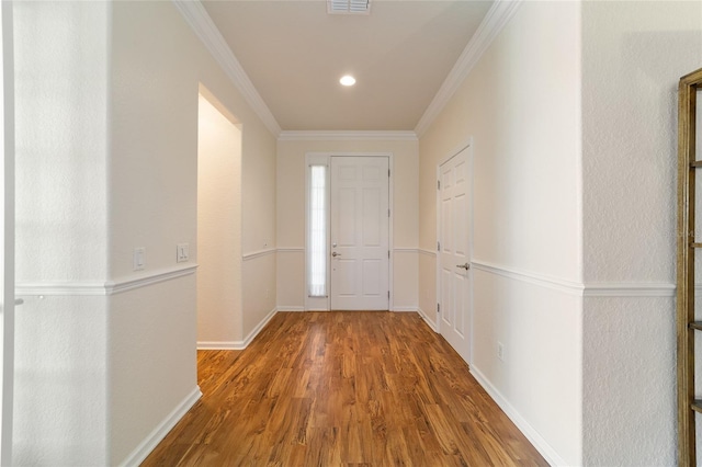 interior space with wood-type flooring and crown molding