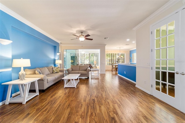 living room featuring dark hardwood / wood-style floors, ceiling fan, and ornamental molding