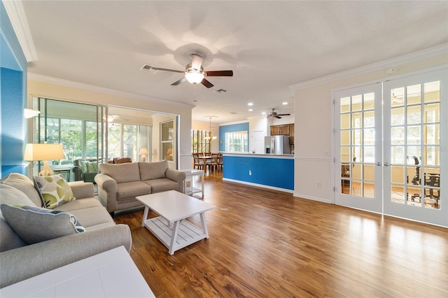 living room featuring ceiling fan, dark hardwood / wood-style flooring, and crown molding