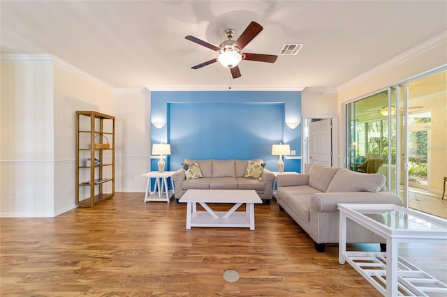 living room with hardwood / wood-style floors, ceiling fan, and ornamental molding