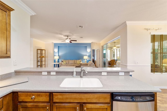 kitchen featuring crown molding, dishwasher, light wood-type flooring, and sink