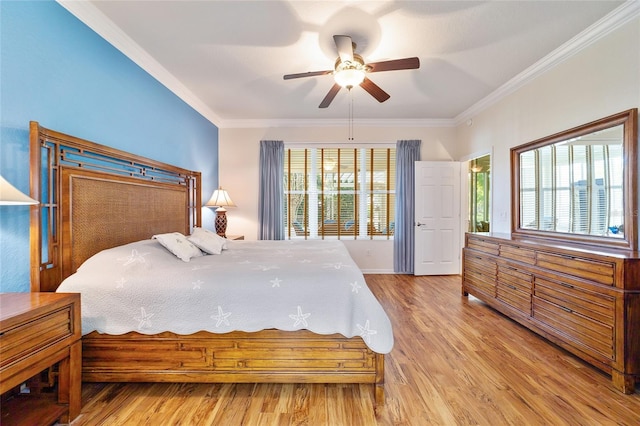 bedroom with multiple windows, hardwood / wood-style flooring, ceiling fan, and ornamental molding