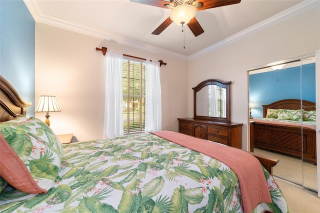 bedroom with carpet flooring, ceiling fan, crown molding, and a closet