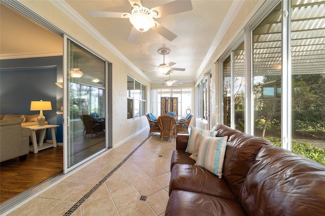 sunroom / solarium featuring ceiling fan