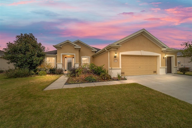 view of front of house featuring a lawn and a garage