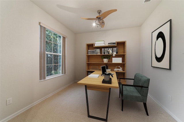 office space featuring ceiling fan and light colored carpet