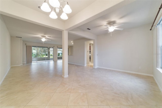 empty room featuring light tile patterned floors and ceiling fan with notable chandelier