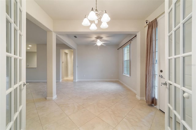 tiled spare room featuring ceiling fan with notable chandelier and french doors