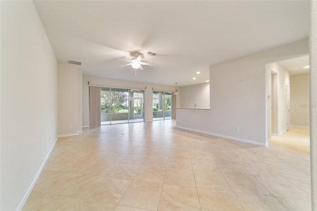 tiled spare room with ceiling fan