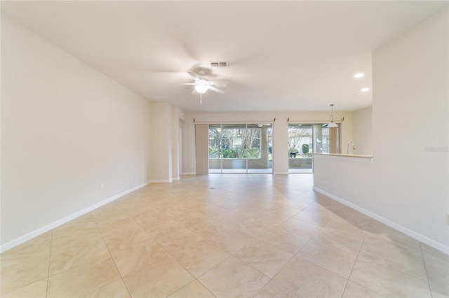 tiled empty room featuring ceiling fan