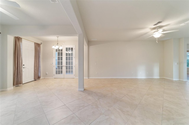 unfurnished room with french doors and ceiling fan with notable chandelier