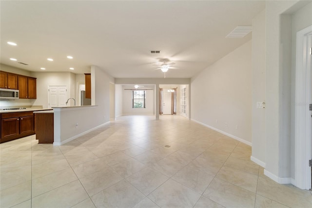 unfurnished living room with ceiling fan and light tile patterned flooring