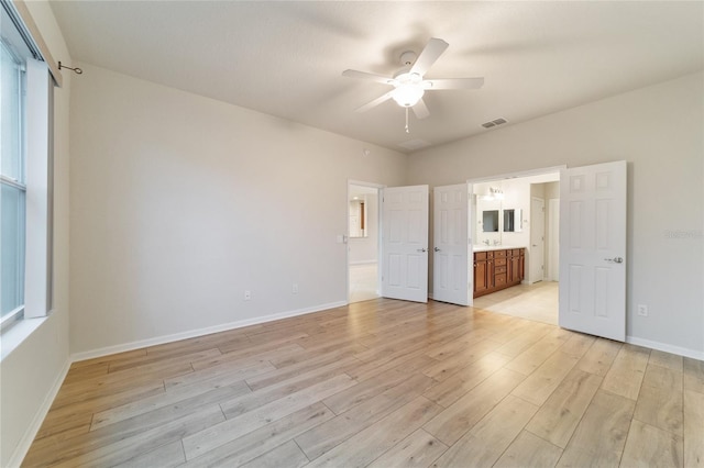 unfurnished bedroom featuring connected bathroom, ceiling fan, and light hardwood / wood-style floors